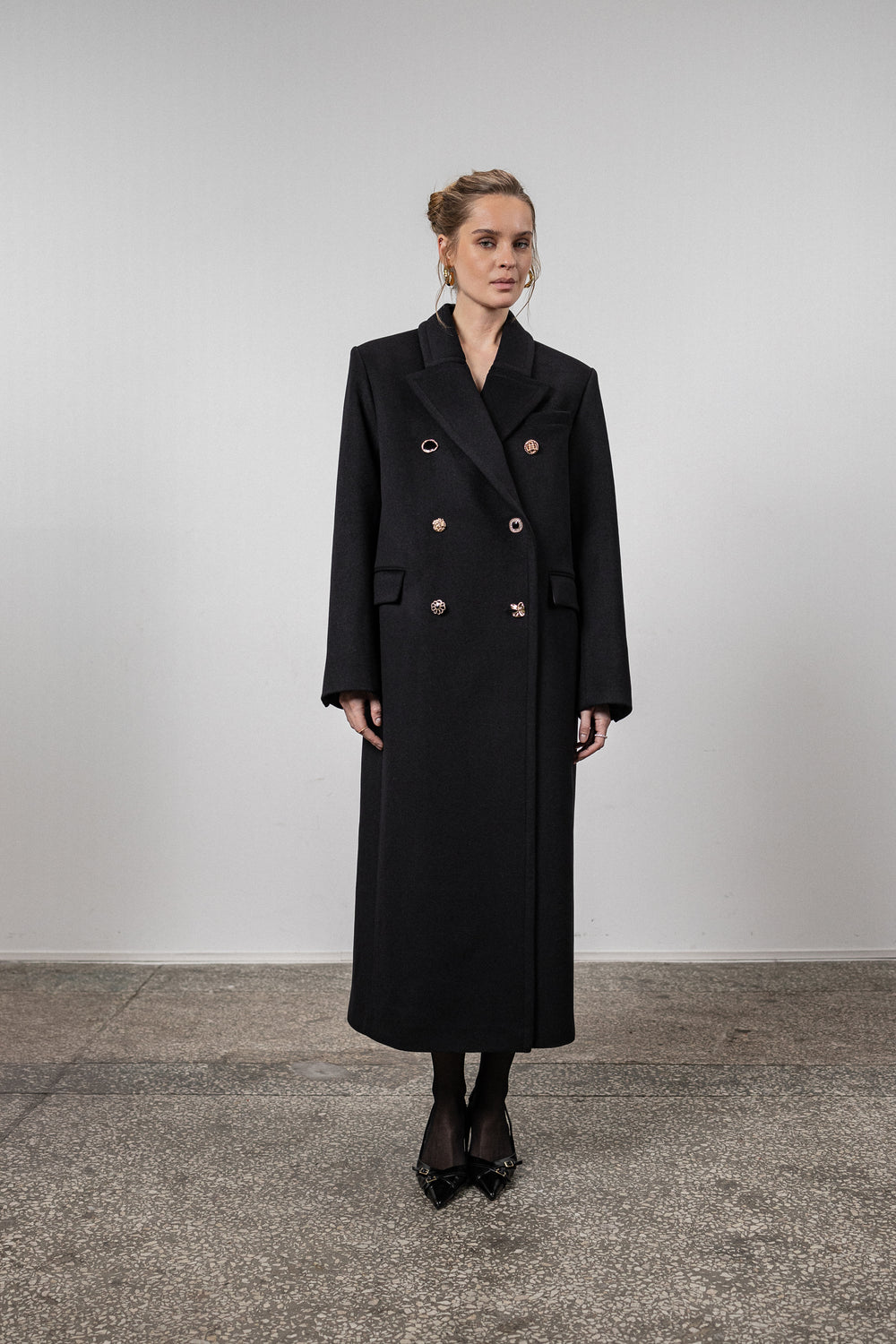 Black coat with various gold buttons