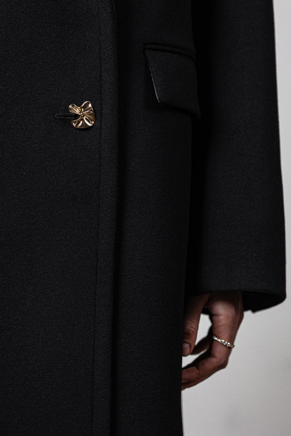 Black coat with various gold buttons